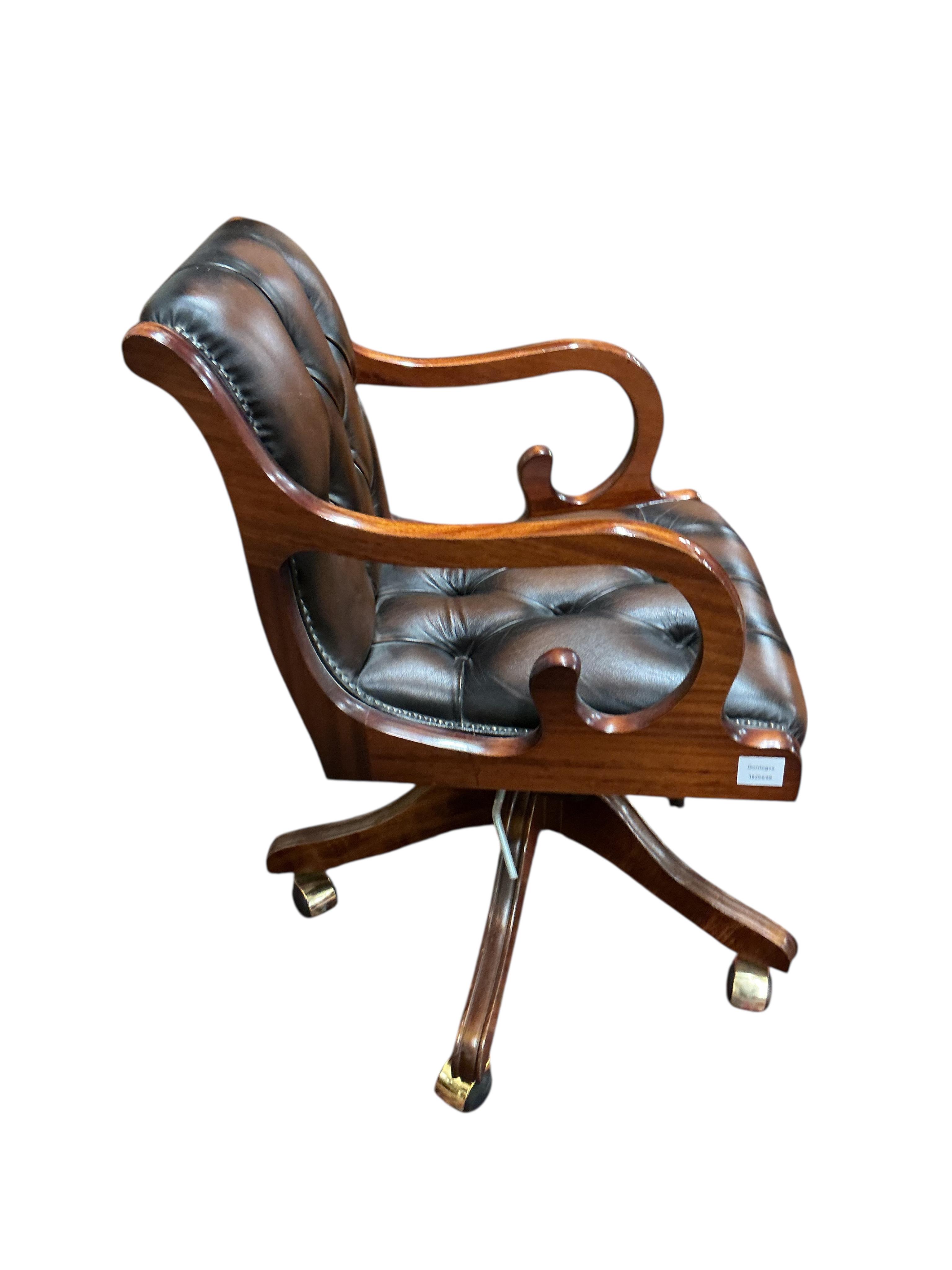 A reproduction buttoned brown leather swivel desk chair, width 51cm, depth 47cm, height 82cm